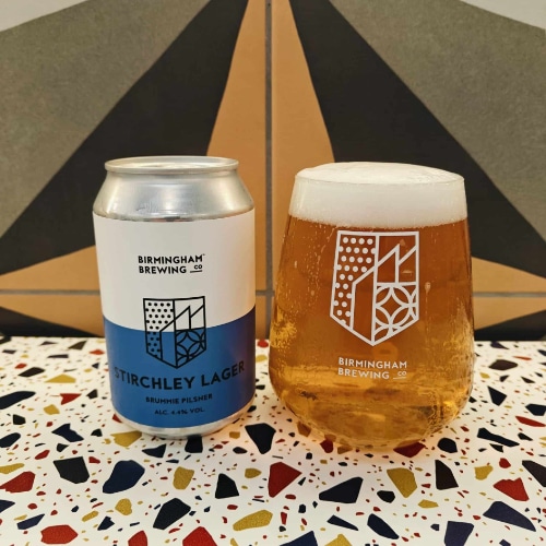 A photo showing Birmingham Brewing Company's Stirchley Lager can and in a special Birmingham Brewing glass